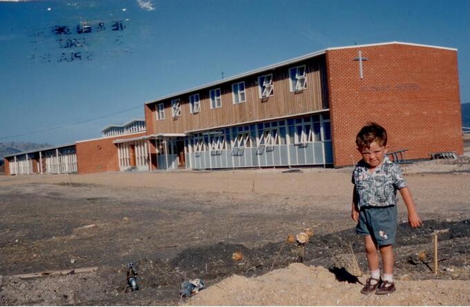 Barry Delaney in front of new school building.jpg